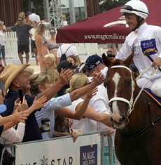 Gerry Harvey and Katie Page reach out to greet Damian Browne during the Magic Millions beach gallops promotion on the Tuesday before the Magic Millions raceday. A couple of days later Browne was rushed to hospital with a perforated bowel.

Photos: Graham Potter

This column joins many others in wishing Damian Browne well in his recovery.