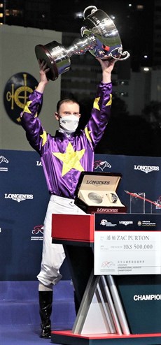 Zac Purton displaying the Hong Kong Longines International Jockeys Championship (IJC) trophy at Happy Valley on Wednesday night