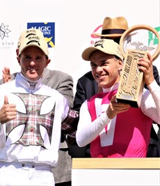 Tommy Berry presents Maloney with the big race trophy ...