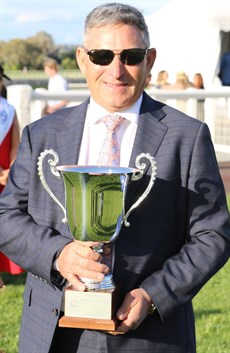 Tony Sears with the trophy after Adelad had won the Magic Millions Garden City Guineas in style