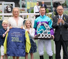 Zac Purton and his family with The Hon Martin Liao, Chairman, The Hong Kong Jockey Club, after the Australian rode a 2000th winner in Hong Kong.